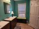 Well-lit bathroom with a single vanity, tiled floor, and green walls at 118 Lucia Se Dr, Smyrna, GA 30082