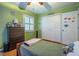 bedroom with a bed, dresser, green walls, and wood floors at 118 Lucia Se Dr, Smyrna, GA 30082