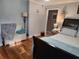 Comfortable bedroom featuring hardwood floors, large bed, and classic furnishings at 118 Lucia Se Dr, Smyrna, GA 30082