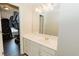 Bathroom with vanity, sink, and mirror, conveniently located near the closet at 9919 Bridgewater Pointe, Villa Rica, GA 30180