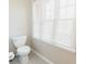 Bathroom with toilet and window, offering natural light at 9919 Bridgewater Pointe, Villa Rica, GA 30180