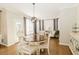 Bright dining room features a round table, six chairs, and built-in hutch at 9919 Bridgewater Pointe, Villa Rica, GA 30180