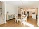 Open concept dining room with kitchen view, hardwood floors, and round table at 9919 Bridgewater Pointe, Villa Rica, GA 30180