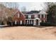 Two-story brick home with a large front porch and landscaped yard at 9919 Bridgewater Pointe, Villa Rica, GA 30180