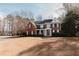 Two-story brick home with a large front porch and landscaped yard at 9919 Bridgewater Pointe, Villa Rica, GA 30180