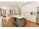 Bright kitchen with white cabinets, large island, and hardwood floors at 9919 Bridgewater Pointe, Villa Rica, GA 30180