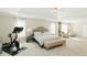 Main bedroom with carpeted floors, large bed, and exercise bike at 9919 Bridgewater Pointe, Villa Rica, GA 30180