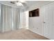 Bedroom with carpet flooring, ceiling fan, and large TV at 1731 Pryor Sw Rd # 104, Atlanta, GA 30315