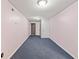 Long basement hallway with blue carpet and doors at 215 Silver Creek Ln, Stockbridge, GA 30281