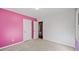 Bedroom with pink and white walls and carpeted floor at 215 Silver Creek Ln, Stockbridge, GA 30281