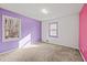 Bedroom with purple and pink walls and carpeted floor at 215 Silver Creek Ln, Stockbridge, GA 30281