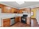 Kitchen features wood cabinets, stainless steel appliances, and laminate flooring at 215 Silver Creek Ln, Stockbridge, GA 30281