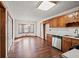 Bright kitchen with wood cabinets, stainless steel dishwasher, and laminate flooring at 215 Silver Creek Ln, Stockbridge, GA 30281