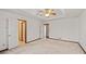 Main bedroom with high ceilings, ceiling fan and carpet at 215 Silver Creek Ln, Stockbridge, GA 30281