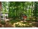 Large backyard with playset and wooded area, offering privacy at 4848 Green Forest Nw Ct, Acworth, GA 30102