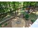 Wooded backyard with a fire pit and playhouse at 4848 Green Forest Nw Ct, Acworth, GA 30102