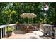 Deck with wooded views, table and chairs, and plenty of shade at 4848 Green Forest Nw Ct, Acworth, GA 30102