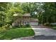 House exterior showcasing a manicured lawn and wooded surroundings at 4848 Green Forest Nw Ct, Acworth, GA 30102