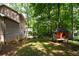 Back exterior view of house showing a large yard and playset at 4848 Green Forest Nw Ct, Acworth, GA 30102
