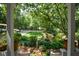 Landscaped yard with lush greenery, stone accents, and a serene atmosphere at 4848 Green Forest Nw Ct, Acworth, GA 30102