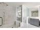 Elegant bathroom featuring marble tile shower with glass enclosure and vanity with storage at 2660 Peachtree Nw Rd # 25H, Atlanta, GA 30305