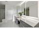 Bright bathroom featuring double vanity, large mirrors, and a separate shower area at 2660 Peachtree Nw Rd # 25H, Atlanta, GA 30305