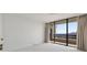 Cozy bedroom featuring large windows and access to a private balcony at 2660 Peachtree Nw Rd # 25H, Atlanta, GA 30305