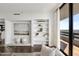 Open-concept living area showcases custom shelving and dark wood flooring at 2660 Peachtree Nw Rd # 25H, Atlanta, GA 30305