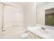 Bathroom featuring a combination tub and shower with a large mirror over the single sink at 3712 Berkeley Xing, Duluth, GA 30096