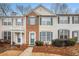 Attractive townhome facade with brick accents and teal shutters at 3712 Berkeley Xing, Duluth, GA 30096