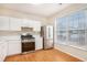 Bright kitchen with stainless steel appliances and wood floors at 3712 Berkeley Xing, Duluth, GA 30096