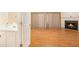 Open-concept living area features wood floors, fireplace, and powder room at 3712 Berkeley Xing, Duluth, GA 30096
