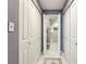 Bright bathroom hallway with white doors and a glimpse of the tiled shower at 64 Devon Ln, Avondale Estates, GA 30002
