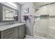 Updated bathroom with a gray vanity, marble countertop, and glass-enclosed shower at 64 Devon Ln, Avondale Estates, GA 30002