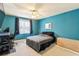Bedroom featuring blue walls and standard ceiling fan at 64 Devon Ln, Avondale Estates, GA 30002