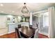 Open-concept dining area with a modern light fixture and access to an outdoor patio at 64 Devon Ln, Avondale Estates, GA 30002