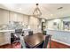 Bright dining area with desk and gray cabinets and a modern light fixture at 64 Devon Ln, Avondale Estates, GA 30002