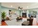 Cozy living room with a fireplace, balcony access, and a ceiling fan for a comfortable atmosphere at 64 Devon Ln, Avondale Estates, GA 30002