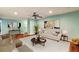 Bright living room featuring hardwood floors, modern decor, and a ceiling fan for added comfort at 64 Devon Ln, Avondale Estates, GA 30002