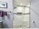 Modern shower with marble-like tile, a built-in seat, and decorative mosaic accents at 64 Devon Ln, Avondale Estates, GA 30002