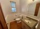 Clean bathroom with granite vanity, wood flooring, and a white toilet at 10995 Parsons Rd, Johns Creek, GA 30097
