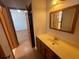 Bathroom with wood vanity, sink and mirror at 10995 Parsons Rd, Johns Creek, GA 30097
