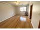 Hardwood floor bedroom with ceiling fan and window at 10995 Parsons Rd, Johns Creek, GA 30097