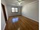 Hardwood floors and neutral walls in this bright bedroom at 10995 Parsons Rd, Johns Creek, GA 30097