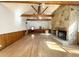 Large Gathering room with hardwood floors, stone fireplace and wood beams at 10995 Parsons Rd, Johns Creek, GA 30097