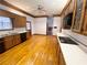 Spacious kitchen featuring wood cabinets, hardwood floors, and modern appliances at 10995 Parsons Rd, Johns Creek, GA 30097