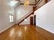 Spacious living room with hardwood floors and a grand staircase at 10995 Parsons Rd, Johns Creek, GA 30097