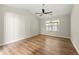 Spacious living room with light walls, wood-look flooring, and a ceiling fan at 217 Overland Trl, Sharpsburg, GA 30277