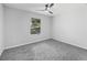 Bedroom with grey carpet, window, and ceiling fan at 2199 Blue Creek Ct, Conley, GA 30288