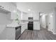 Modern kitchen with white shaker cabinets, quartz countertops, and stainless steel appliances at 2199 Blue Creek Ct, Conley, GA 30288